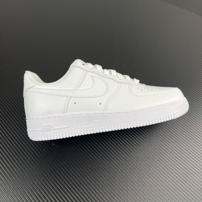 White low-top sneakers with stitched swoosh and lace-up front