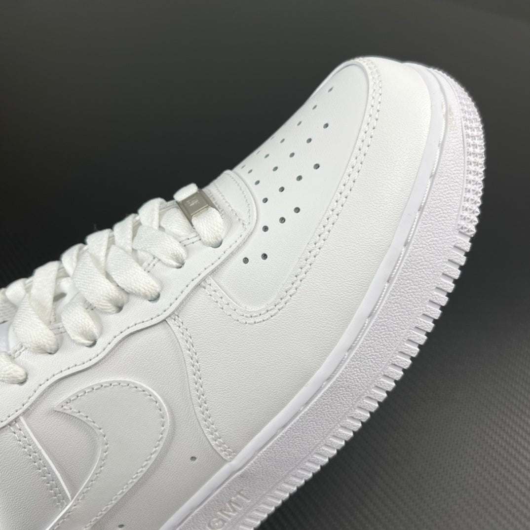 White leather sneakers side view with perforations and lace-up panel