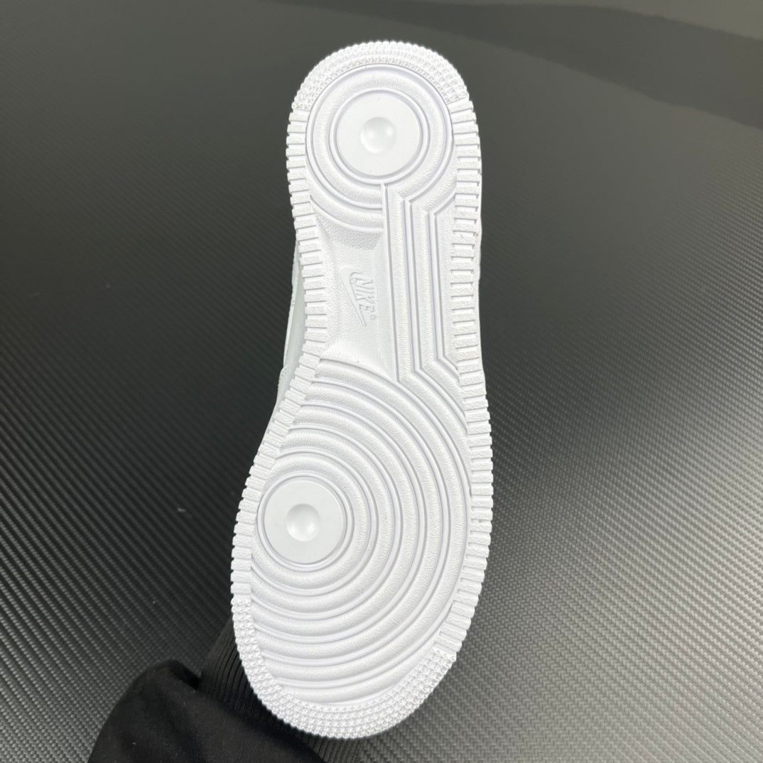 White sneaker outsole with circular traction pattern and raised tread grooves
