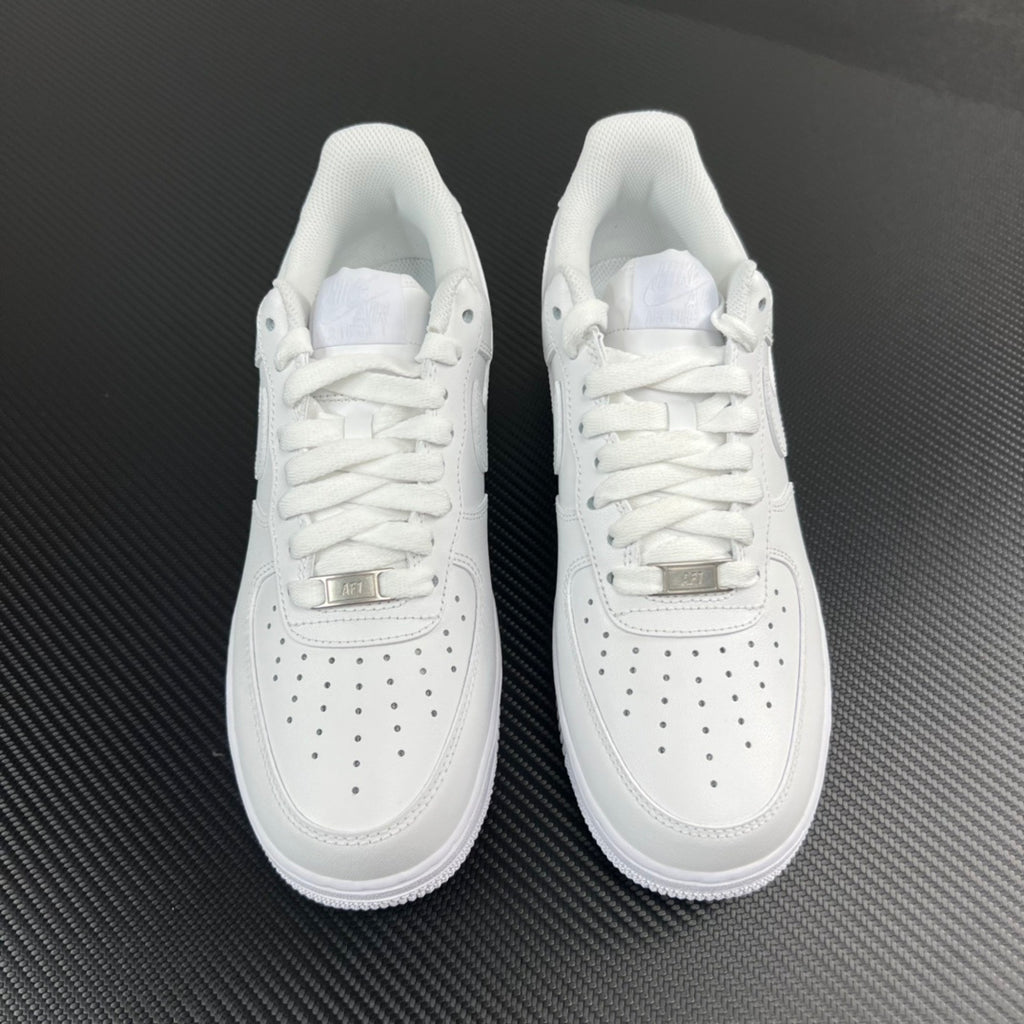Pair of white low-top sneakers, lace-up design with perforated toe panel