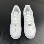 Pair of white low-top sneakers, lace-up design with perforated toe panel