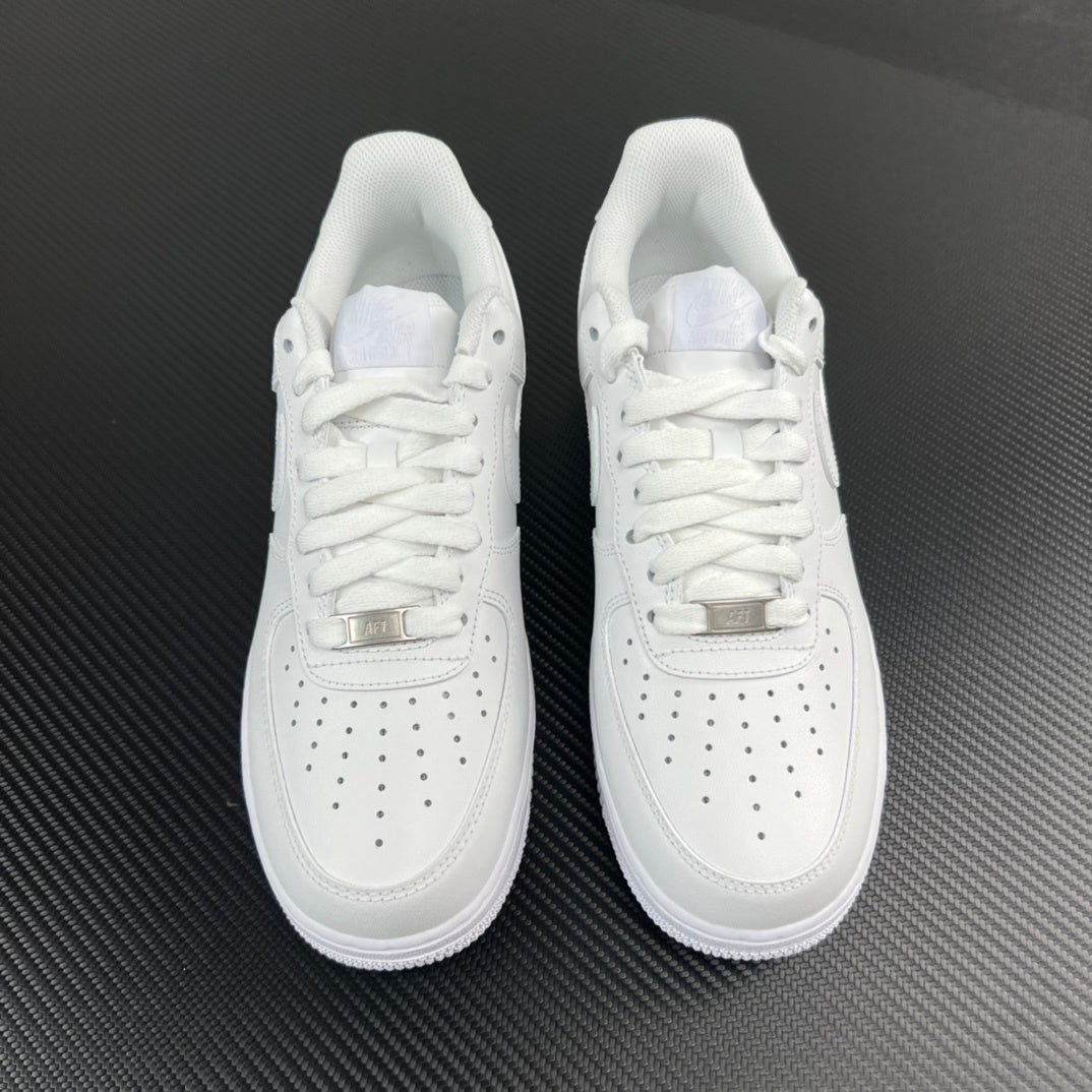 Pair of white low-top sneakers, lace-up design with perforated toe panel