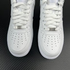White sneaker front view close-up showing laces, perforations, and logo tab