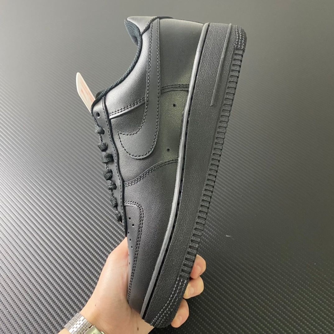 Nike Air Force 1 sneakers, side view with textured outsole, dark leather and swoosh.