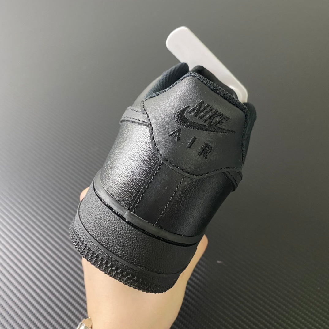 Nike Air Force 1 sneakers, heel view with “AIR” embossing and black midsole, dark leather.
