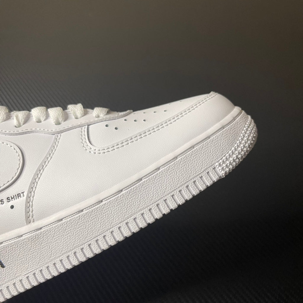 White low-top sneaker with side swoosh and textured rubber sole