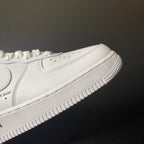 White low-top sneaker with side swoosh and textured rubber sole