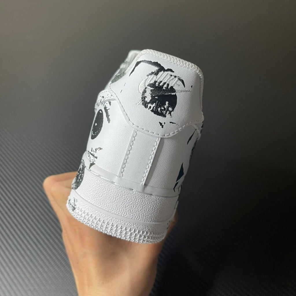 White low-top sneaker heel with black graphic and ridged rubber outsole