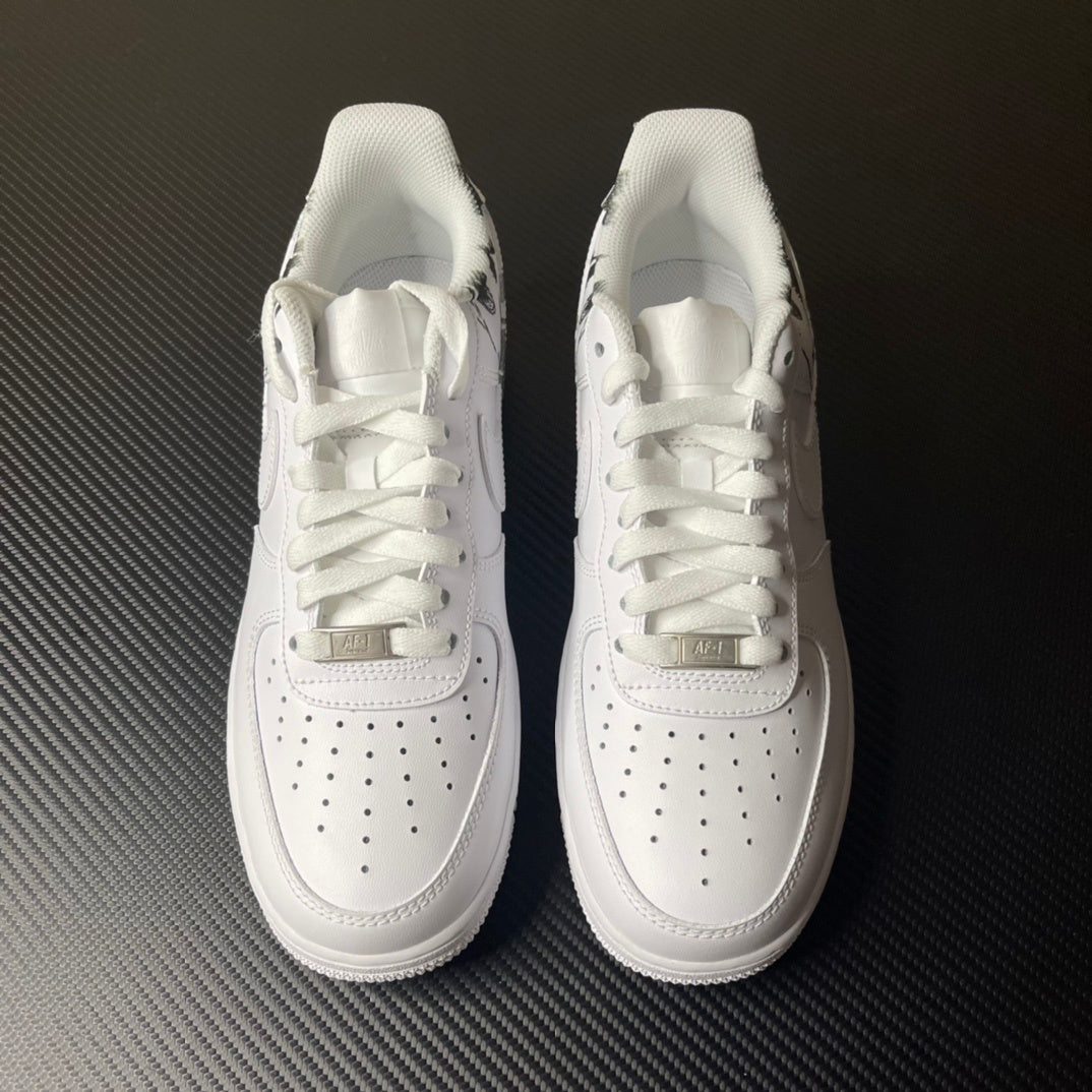 White low-top sneakers with lace-up closure, swoosh logos, and perforated toe