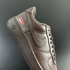 Taupe low-top sneaker heel and side with lace, stitched panels, and 'AIR' lettering.