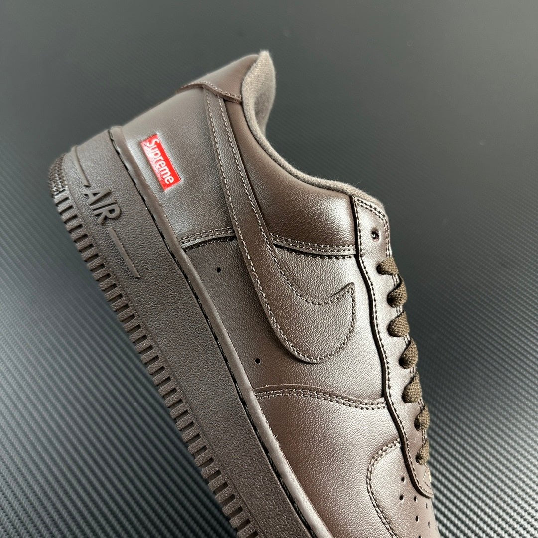 Taupe low-top sneaker heel and side with lace, stitched panels, and 'AIR' lettering.