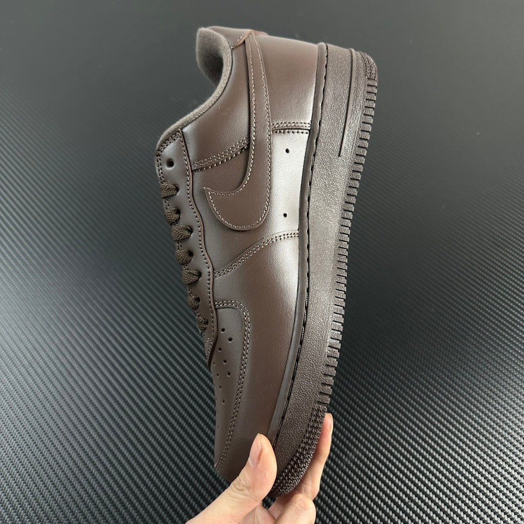 Taupe low-top sneaker side profile with lace, swoosh, and textured rubber sole.