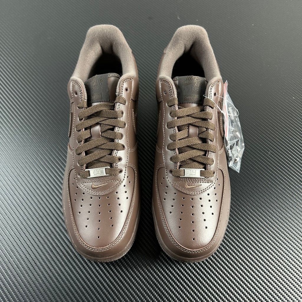 Taupe low-top sneakers front view with lace-up, suede collar, and tongue tags.