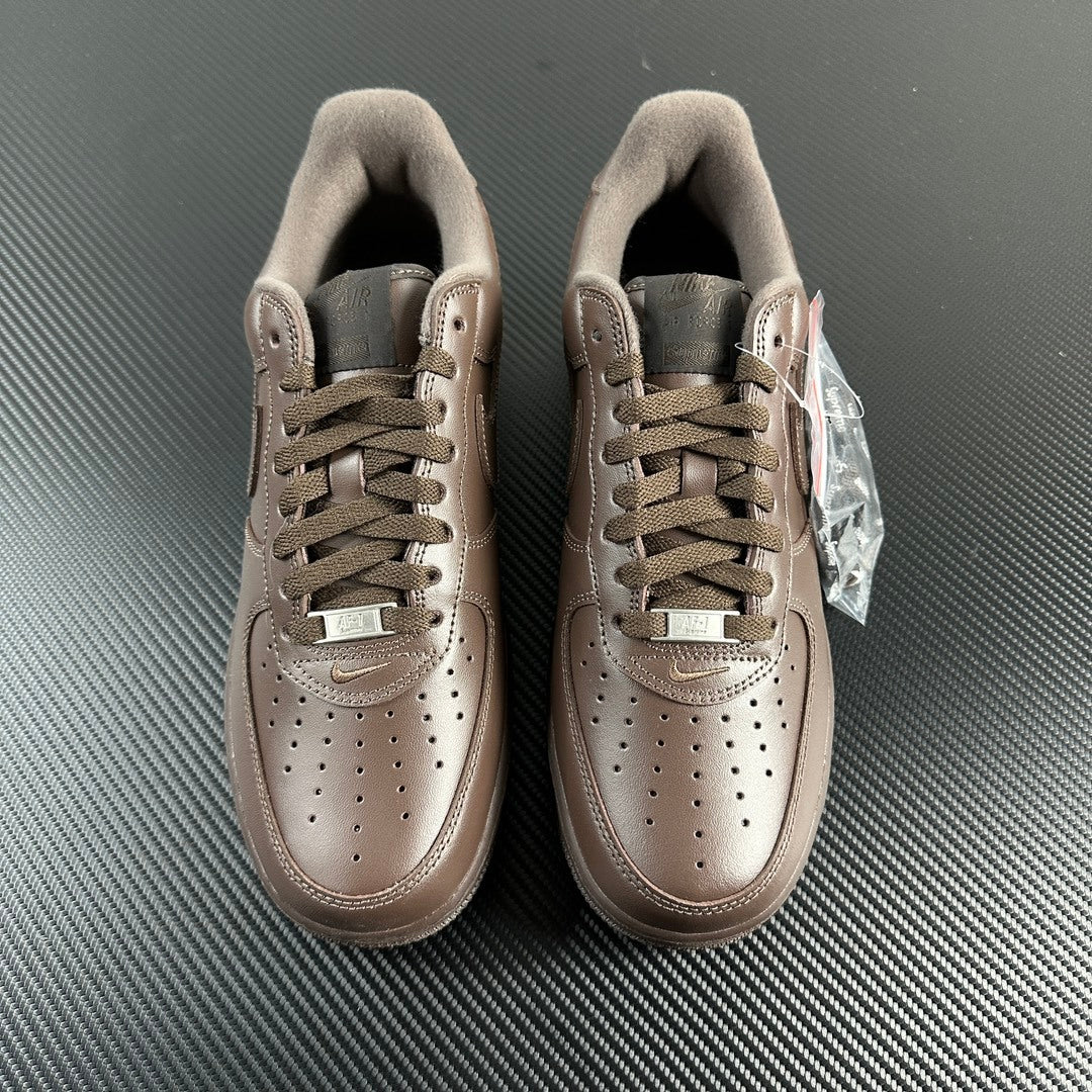 Taupe low-top sneakers front view with lace-up, suede collar, and tongue tags.