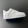 White low-top leather sneakers with swoosh logo and lace-up front