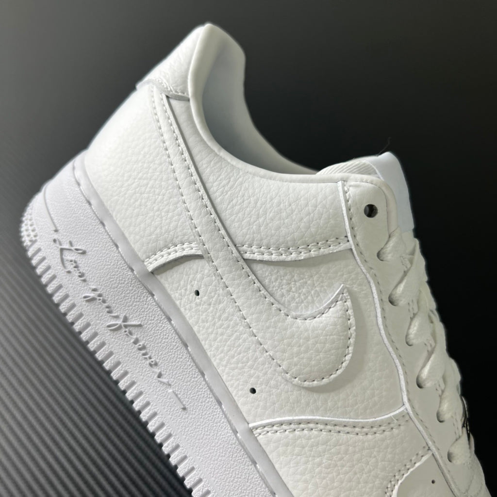 White sneaker side view with stitched overlays, lace eyelets, and padded collar