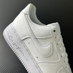 White sneaker side view with stitched overlays, lace eyelets, and padded collar