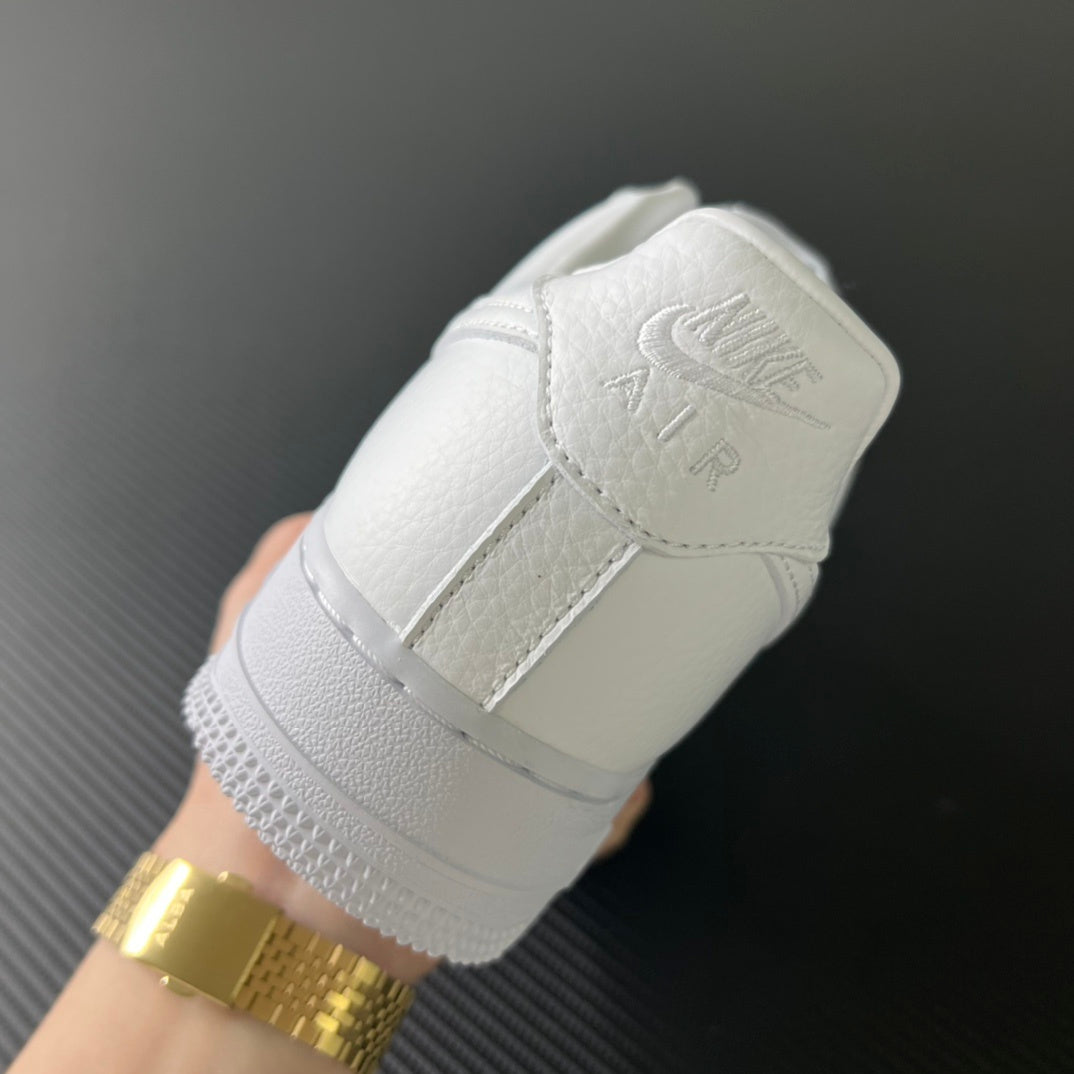 White sneaker heel with strap detail and gold-toned buckle accent