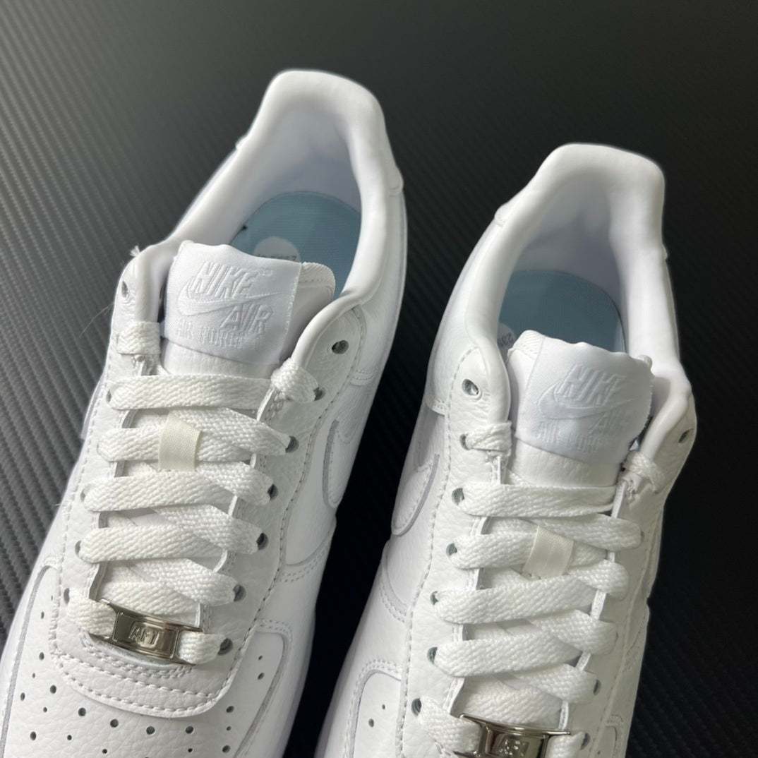 White sneakers with heel padding and lace-up front, shown side-by-side