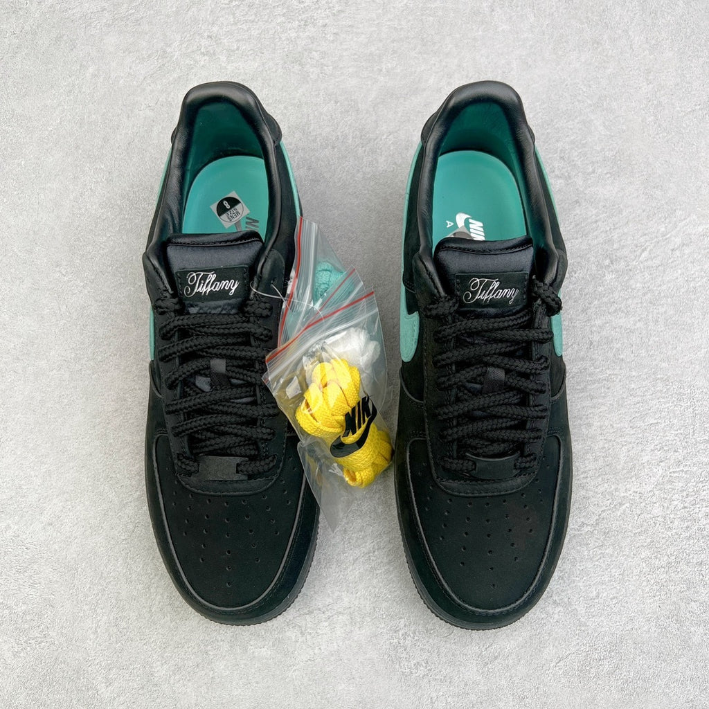 Pair of black Air Force 1 sneakers with teal lining and Tiffany-branded tongue.
