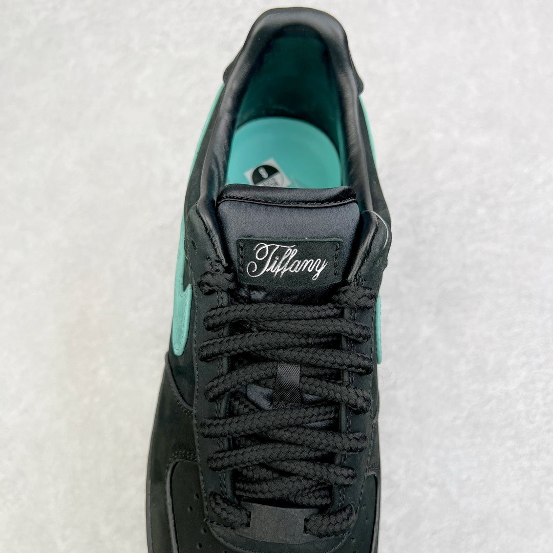 Air Force 1 tongue close-up in black with Tiffany logo patch and teal interior.