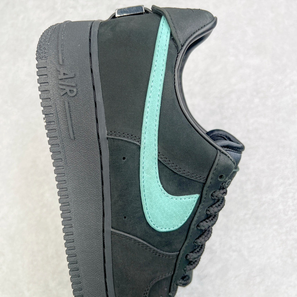 Air Force 1 side view showing black upper, teal swoosh, and AIR-mark midsole.