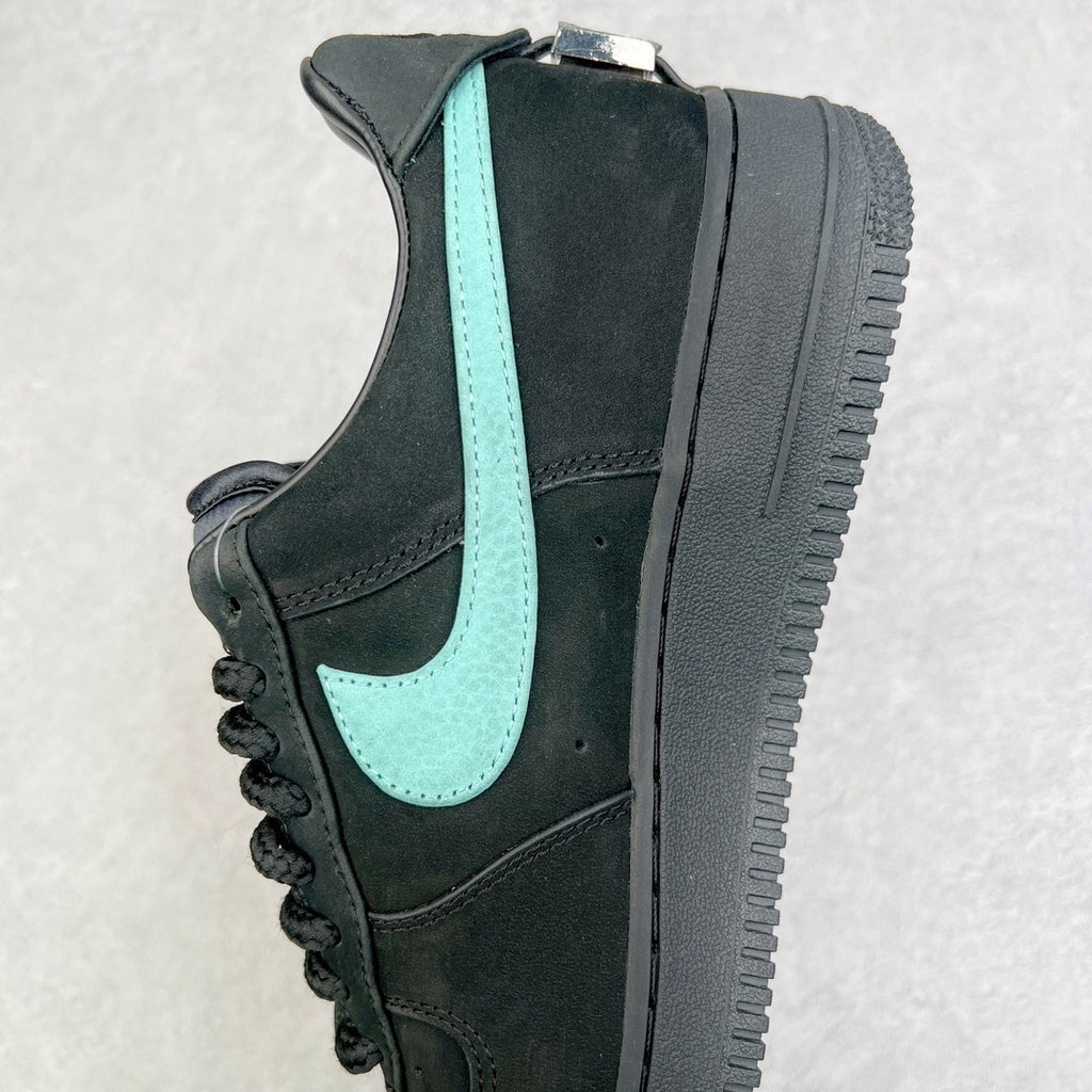 Air Force 1 sneaker side view with black panels and teal swoosh stripe.