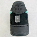 Air Force 1 heel close-up in black with teal accent and metal tag.