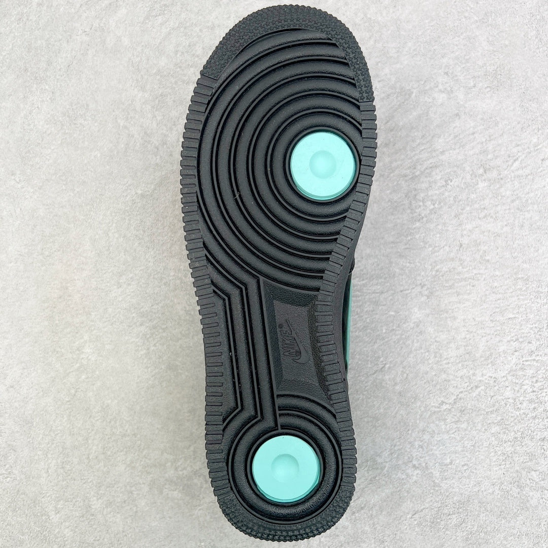 Air Force 1 outsole bottom view with black tread and teal circular inserts.