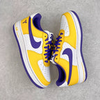 Yellow and white low-top sneakers with purple swoosh, lace-up front, and Air text