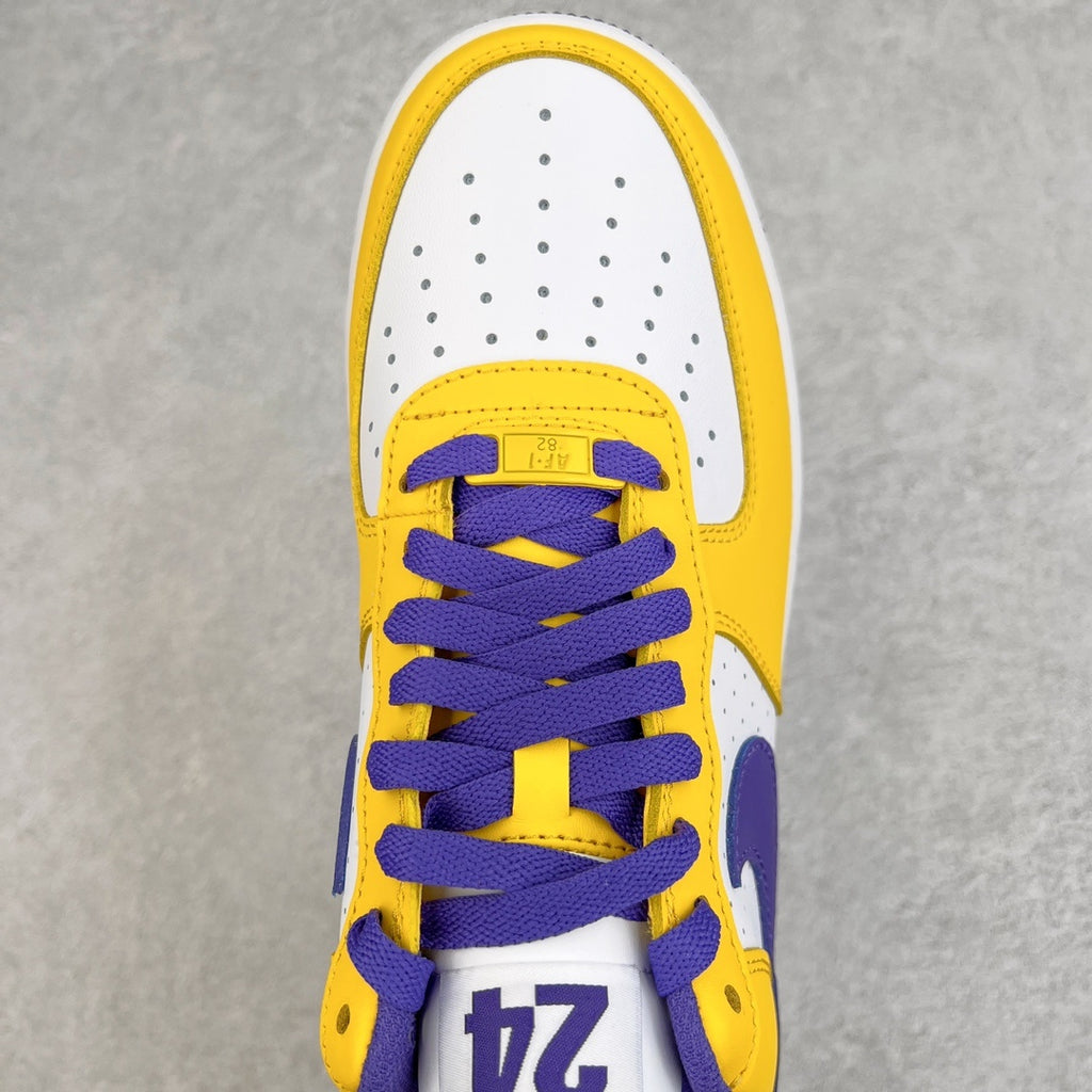 Close-up of white and yellow sneaker tongue with purple laces and "24" patch