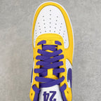 Close-up of white and yellow sneaker tongue with purple laces and "24" patch