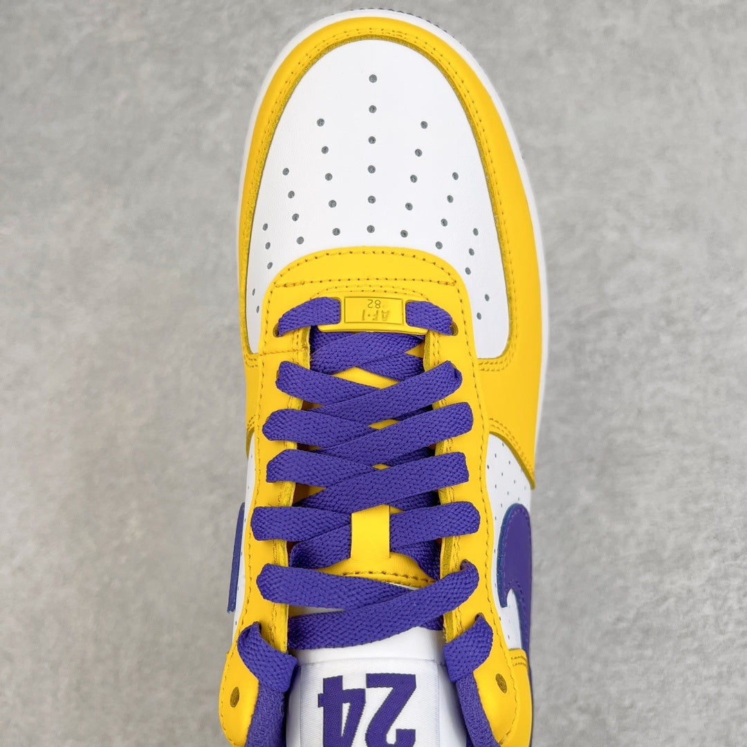 Close-up of white and yellow sneaker tongue with purple laces and "24" patch