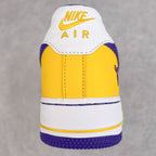 Back view of yellow and white sneakers with Nike Air logo and purple heel