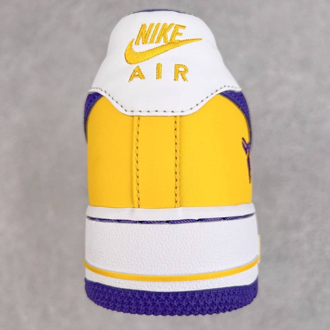 Back view of yellow and white sneakers with Nike Air logo and purple heel