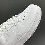 White leather sneakers with Nike swoosh, lace eyelets, and perforated toe