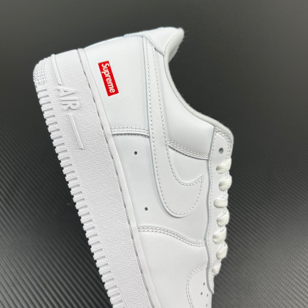 White leather sneakers with red Supreme label on heel and lace strap