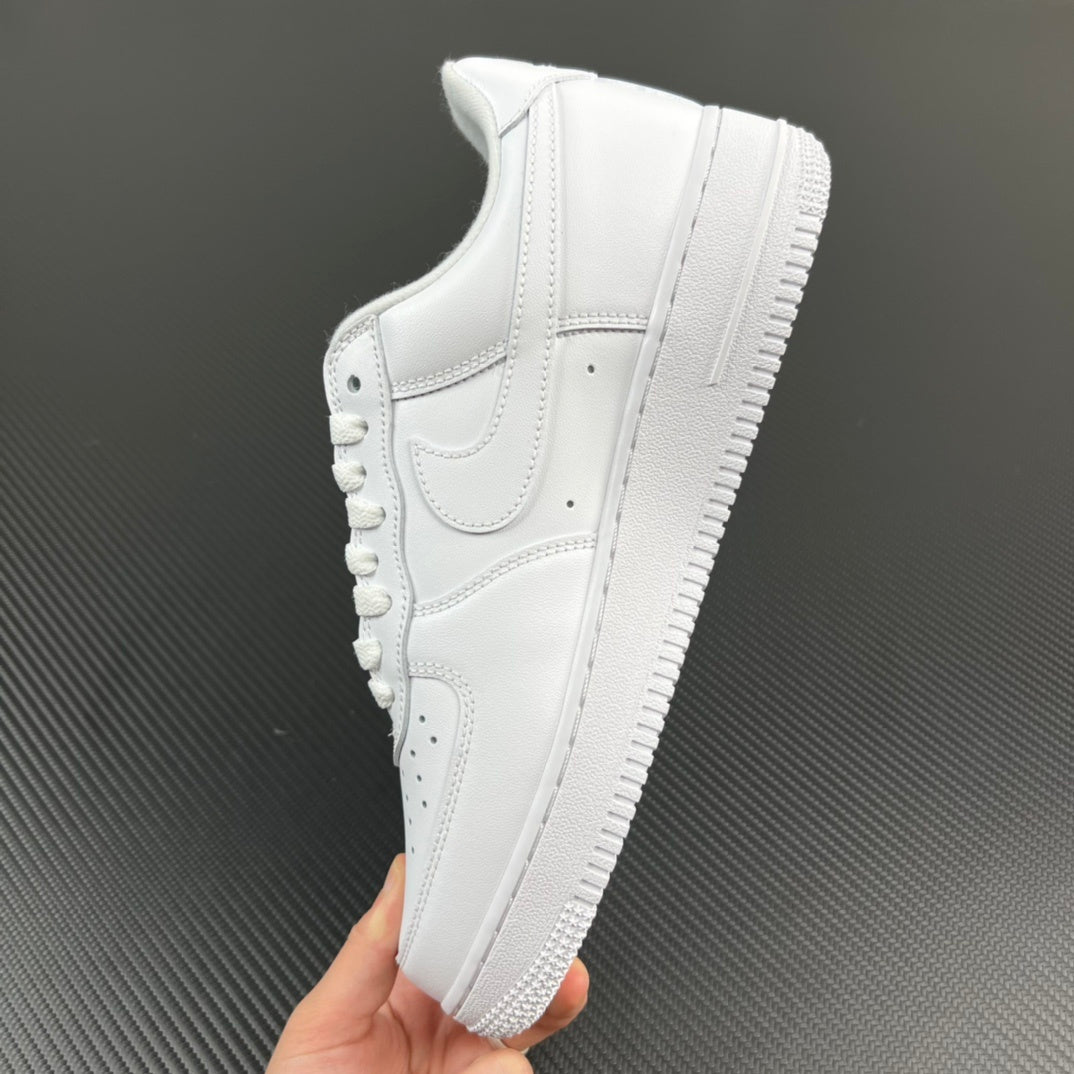 White leather sneakers held in hand, textured midsole and side swoosh