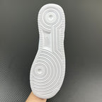 White rubber outsole with circular traction pattern and deep ridged grooves