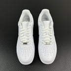 Pair of white low-top sneakers with white laces and perforated toe