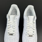 Pair of white sneakers with padded tongue and lace-up front