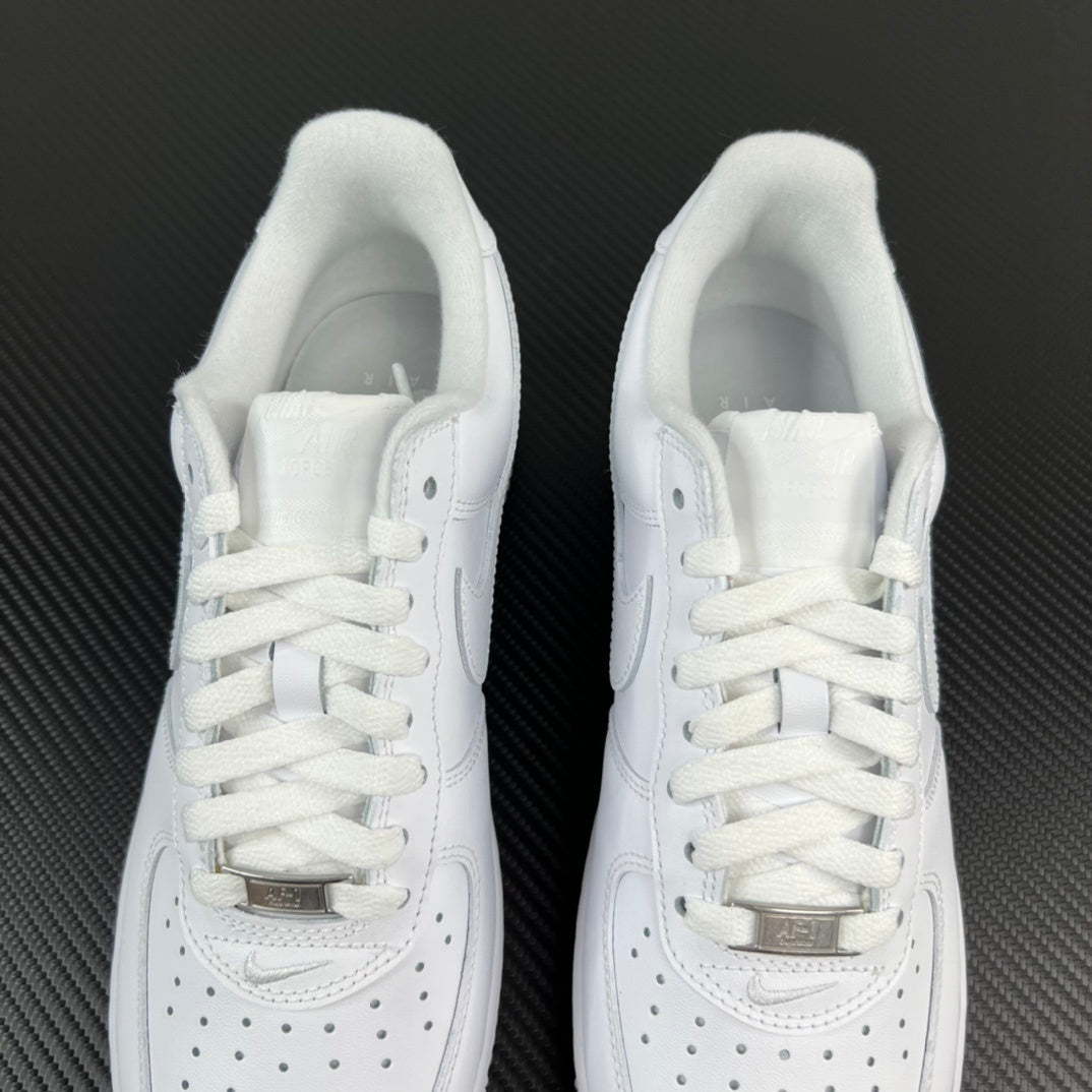 Pair of white sneakers with padded tongue and lace-up front