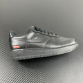 Metallic silver low-top sneakers with Supreme logo on the side and Air text on sole