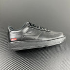 Metallic silver low-top sneakers with Supreme logo on the side and Air text on sole