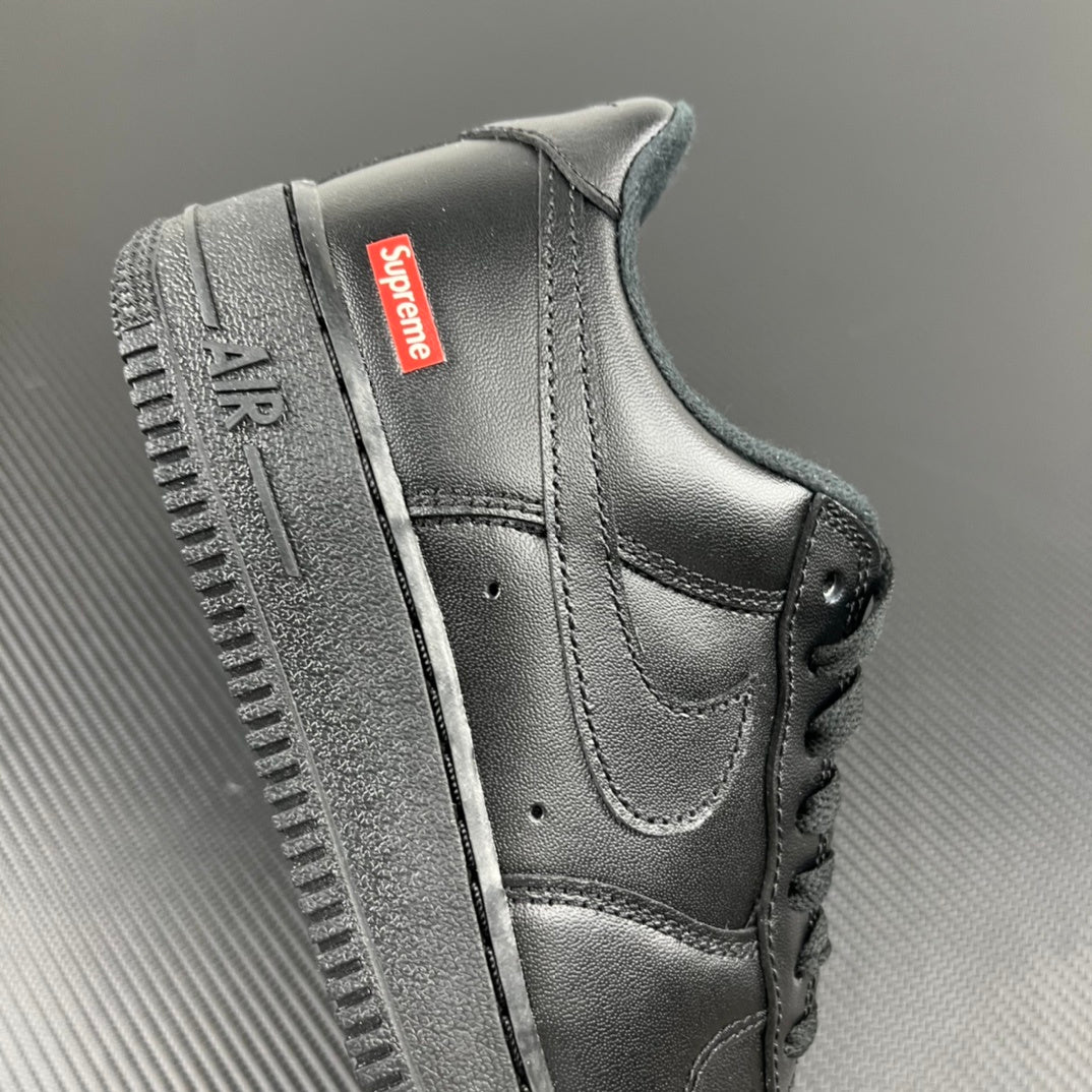 Black leather sneakers with red Supreme label on side and cushioned ankle collar