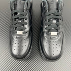 Pair of light gray sneakers with lace-up closure and perforated toe detail