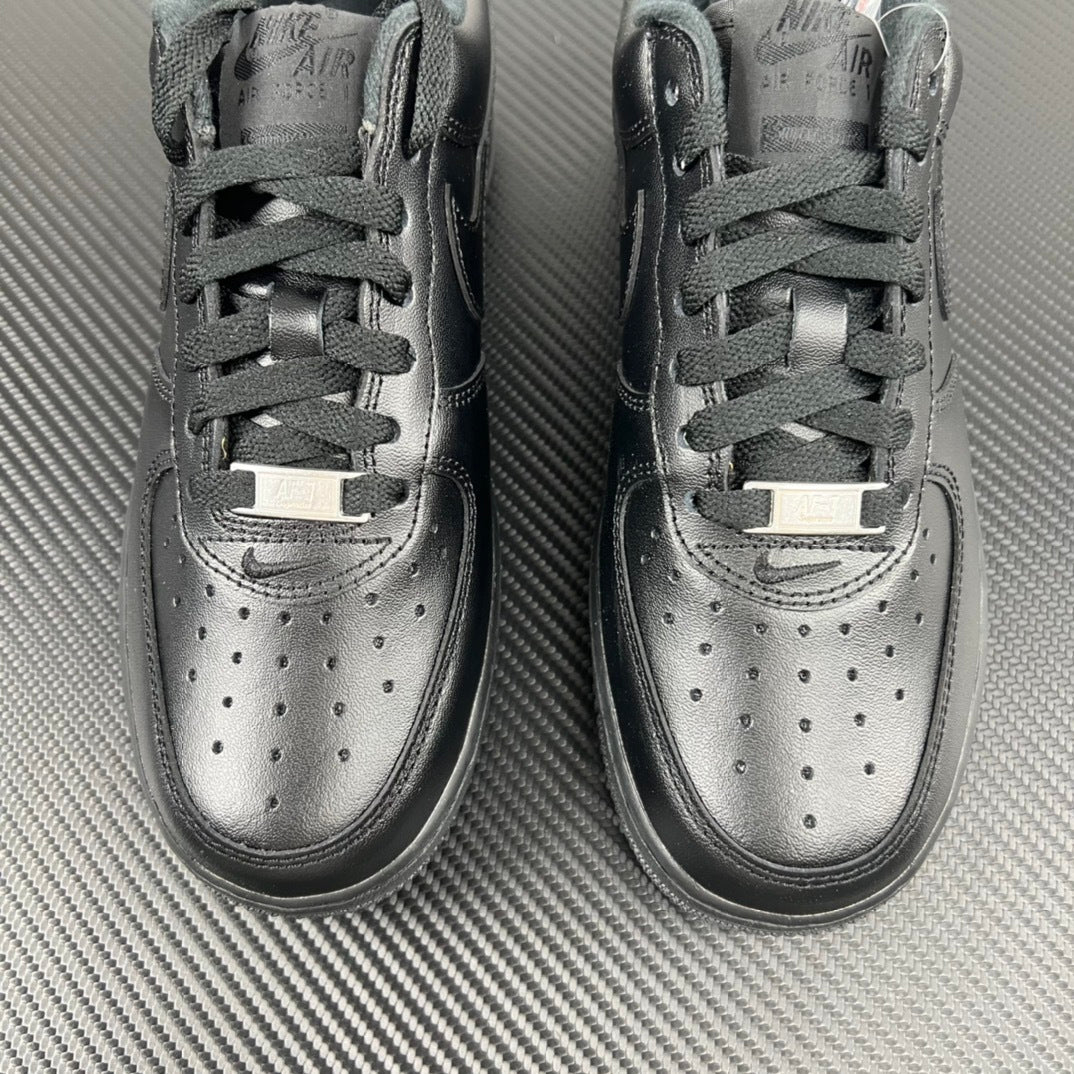 Pair of light gray sneakers with lace-up closure and perforated toe detail