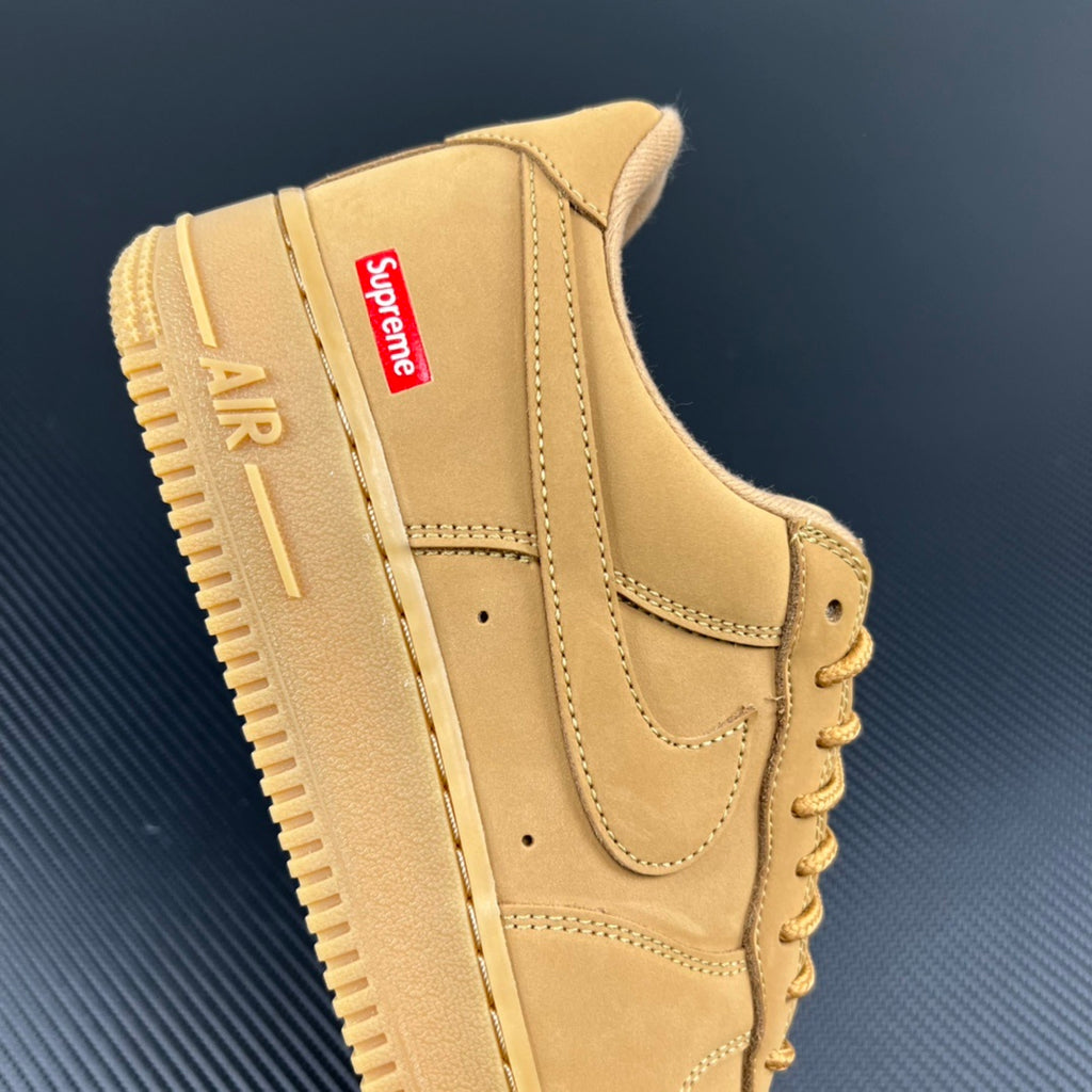 Yellow Air Force 1 sneaker with Supreme logo patch and stitched panels