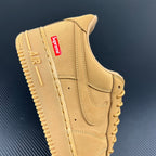 Yellow Air Force 1 sneaker with Supreme logo patch and stitched panels