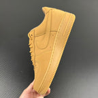 Yellow Air Force 1 sneaker side view with swoosh and lace eyelets